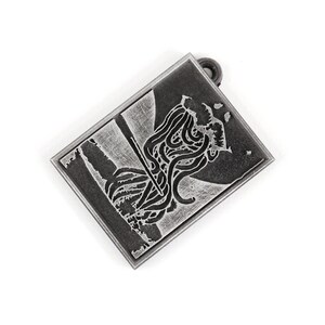 May include: A silver-toned metal pendant with a black and white image of a creature with tentacles. The pendant has a loop at the top for attaching a chain.