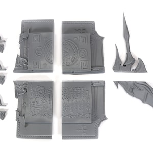 May include: A set of gray plastic pieces for a miniature model. The pieces include a book with intricate details, a spear, and a wing.