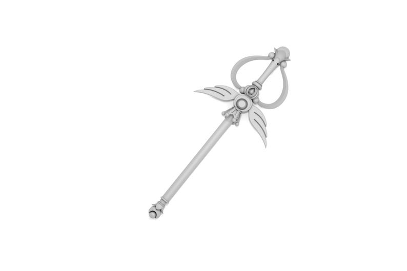 May include: A silver wand with a heart-shaped loop at the top and wings on either side. The wand has a decorative design with a circular element in the center.