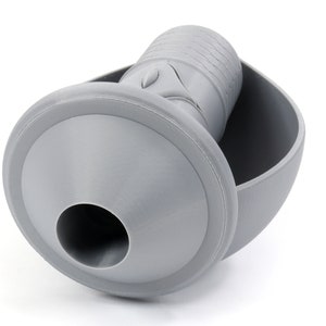 May include: A gray plastic funnel with a round base and a cylindrical spout. The funnel is designed to fit into a round container.