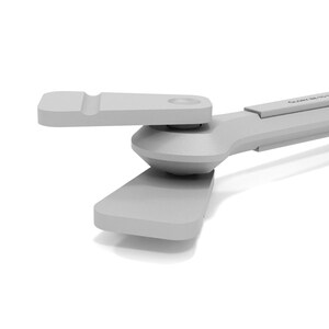 May include: A light gray, mechanical device with a pivoting arm and a rectangular base. The device has a smooth, matte finish and appears to be made of plastic or a similar material. The design is modern and minimalist.