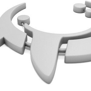 May include: A light gray necklace with a geometric design. The necklace features a curved shape with two circular accents and a pointed pendant. The design is modern and minimalist, with a smooth, matte finish.
