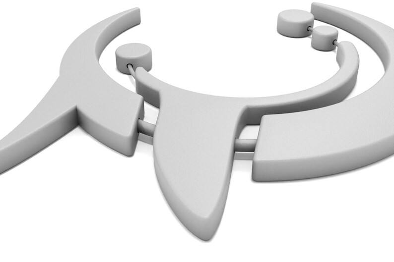 May include: A light gray necklace with a geometric design. The necklace features a curved shape with two circular accents and a pointed pendant. The design is modern and minimalist, with a smooth, matte finish.