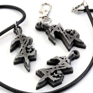 May include: Three silver-colored pendants with a stylized design, one on a black cord necklace, one on a silver chain, and one loose. The pendants feature a geometric design with a sword-like shape.