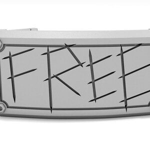 May include: A gray rectangular sign with the word "FREE" carved into it. The sign has a decorative border and is attached to a larger gray structure. The text is cut into the sign.