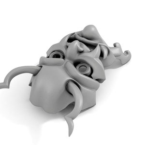 May include: A pair of gray, stylized, ceramic masks with horns and exaggerated features. The masks are stacked on top of each other.