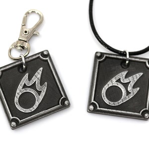 May include: A silver metal keychain and necklace with a black square pendant featuring a silver flame symbol.