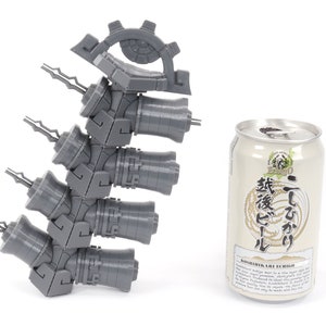 May include: A gray 3D printed model of a mechanical device with a gear and multiple cylinders. The model is about the size of a can of beer.