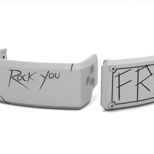 May include: Two gray, curved, rectangular objects with the words "Rock You" and "FREE" in black, stylized lettering. The objects have a geometric design and appear to be made of a solid material.