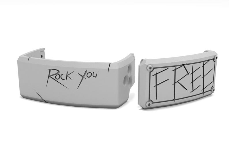 May include: Two gray, curved, rectangular objects with the words "Rock You" and "FREE" in black, stylized lettering. The objects have a geometric design and appear to be made of a solid material.