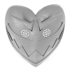 May include: A silver heart-shaped mask with a jagged edge and two eye holes with a grid pattern.