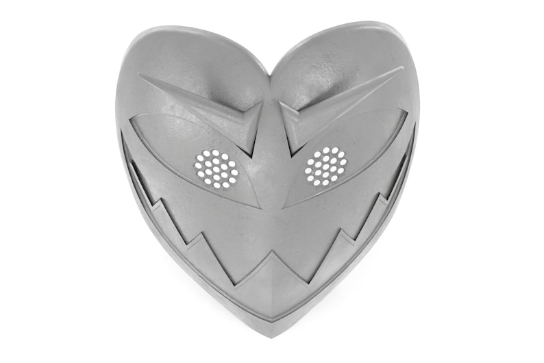 May include: A silver heart-shaped mask with a jagged edge and two eye holes with a grid pattern.