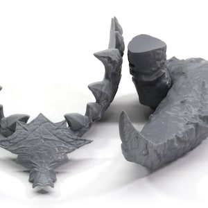 May include: A set of three gray 3D printed dragon teeth, each with a unique shape and texture. The teeth are designed for use in tabletop games or as decorative pieces.
