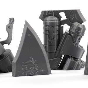 May include: A set of 3D printed gray plastic pieces for a model kit. The pieces are detailed and have intricate designs.