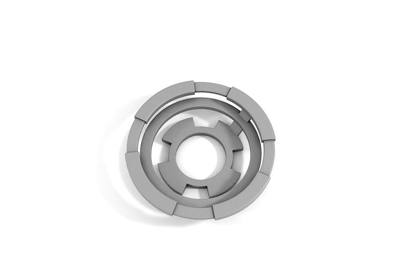 May include: A gray, circular, segmented design with concentric circles and a central hole. The design is made of multiple pieces that fit together.