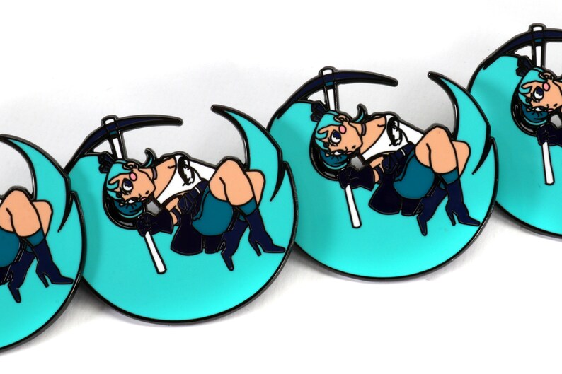 May include: Four turquoise blue enamel pins with a black outline. Each pin features a cartoon character with blue hair, a white shirt, and black pants, sitting on a crescent moon with a pickaxe.