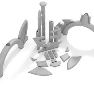 May include: A set of gray plastic building blocks with various shapes and sizes. The blocks are arranged in a circular pattern, with a tall, thin block in the center.
