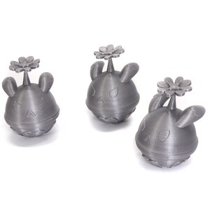 May include: Three silver-colored 3D printed figurines of a cartoon character with a flower on top. The character has a round body, two ears, and a face with eyes and a mouth.