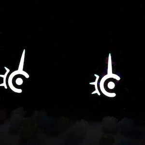 May include: Two white, stylized symbols with a circular base, a central dot, and a pointed top, set against a black background. The symbols have a sunburst-like design on the left side. The image has a glowing effect.