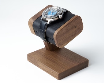 Wooden watch stand with genuine leather top part for storage of men's wristwatch or bracelet may be personalized.