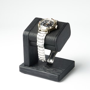 Black single watch stand with leather top for storage of men's watch may be personalized