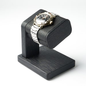 Black single watch stand with leather top for storage of men&#39;s watch may be personalized