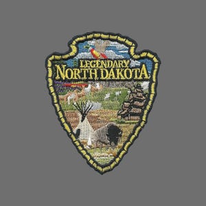 May include: A black and yellow embroidered patch with the text "Legendary North Dakota". The patch features a variety of images including a buffalo, a teepee, a ship, and a bird.