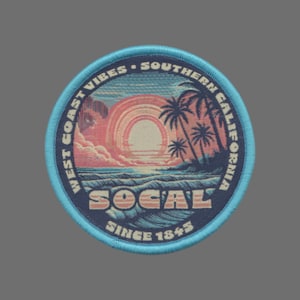 May include: A round, blue patch with a sunset scene and palm trees. The text "West Coast Vibes - Southern California" is written around the edge of the patch. The text "SoCal" is written in a retro font in the center of the patch. The text "Since 1845" is written below the text "SoCal".