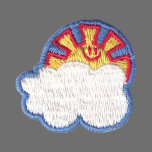 May include: Embroidered patch featuring a smiling sun with yellow rays and a red outline, set against a blue sky. The sun is above a white cloud with a blue border. The patch is likely for clothing or accessories.