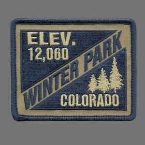May include: A tan and blue embroidered patch with the text "ELEV. 12,000 WINTER PARK COLORADO" and a graphic of three pine trees.