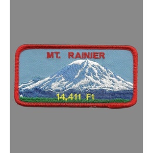 May include: A red, white, and blue embroidered patch with a mountain scene and the text "MT. RAINIER 14,411 Ft."