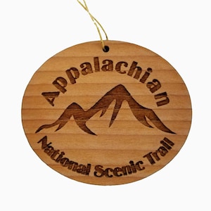 May include: A round wooden ornament with the text "Appalachian National Scenic Trail" and a stylized image of mountains.