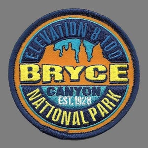 May include: A blue and orange embroidered patch with the text "Elevation 8,100 Bryce Canyon National Park Est. 1928".