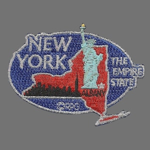 May include: Embroidered patch depicting the outline of New York state in red and blue, with the Statue of Liberty and the words "NEW YORK THE EMPIRE STATE" in white.