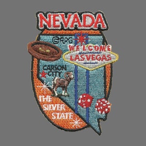 May include: Embroidered patch depicting the state of Nevada with the text "Nevada, The Silver State" and various icons including a cowboy hat, a ram, a dice, and the "Welcome to Las Vegas" sign.