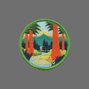 May include: A green, round embroidered patch with a scene of redwoods, a blue sky, and a yellow sun. The text "CALIFORNIA REDWOODS" is embroidered in yellow on the patch.