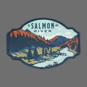 May include: A blue, green, and orange embroidered patch with the text "Id. Salmon River Us." and a depiction of a river flowing through a mountain valley.