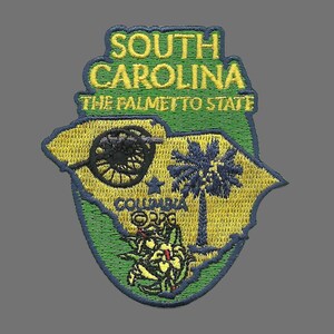 May include: Embroidered patch featuring the outline of South Carolina in yellow and green, with the text "SOUTH CAROLINA THE PALMETTO STATE." Includes a palmetto tree, a crescent moon, and a cannon. The city of Columbia is also noted.