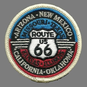 May include: A white, blue, and red embroidered patch with the text "Route US 66" and the names of states along the route: Arizona, New Mexico, Texas, Oklahoma, Kansas, Illinois, Missouri, and California.