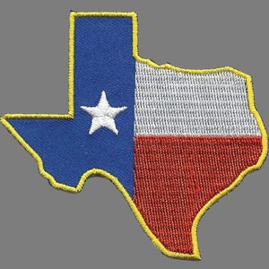 May include: An embroidered patch in the shape of the state of Texas with the Texas flag colours of blue, white, and red. The patch has a yellow outline.
