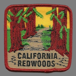 May include: A red, yellow, and green embroidered patch with the words "CALIFORNIA REDWOODS" in black lettering. The patch depicts a path through a redwood forest.