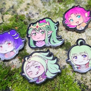 May include: Five anime-style character pins with black outlines. The pins feature characters with purple, pink, and green hair. The pins are set against a mossy background, with each character having a unique design.