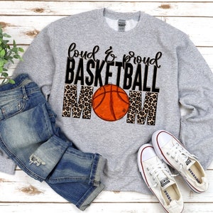 May include: Grey sweatshirt with the text "Loud & Proud Basketball Mom" in black lettering with a basketball and leopard print design.