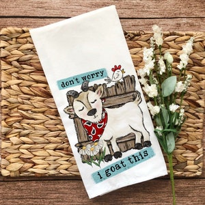 May include: White kitchen towel with a cartoon goat wearing a red bandana and the text "don't worry i goat this".