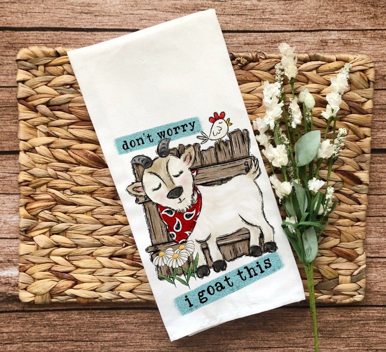 May include: White kitchen towel with a cartoon goat wearing a red bandana and the text "don't worry i goat this".