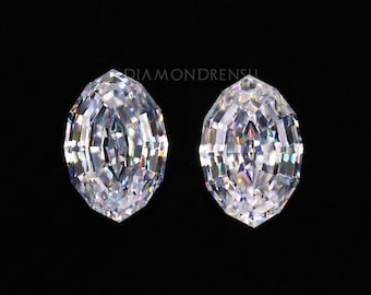 May include: Two oval-shaped, clear, faceted gemstones in a black velvet box. The gemstones are set in a black velvet box with a black background.