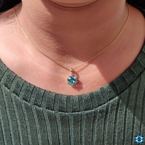 Complete look of the Blue Moissanite Pendant with its elegant gold chain, perfect as gifts for her