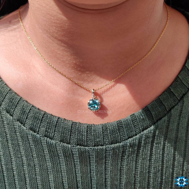 Complete look of the Blue Moissanite Pendant with its elegant gold chain, perfect as gifts for her