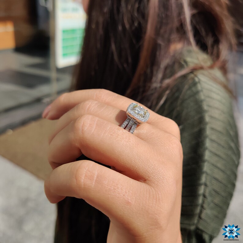 Moissanite engagement ring reflecting rainbow light from every angle.