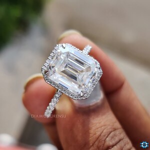 Close-up of VVS clarity emerald cut moissanite ring, focusing on the precision of the cut and the brilliance of the halo setting